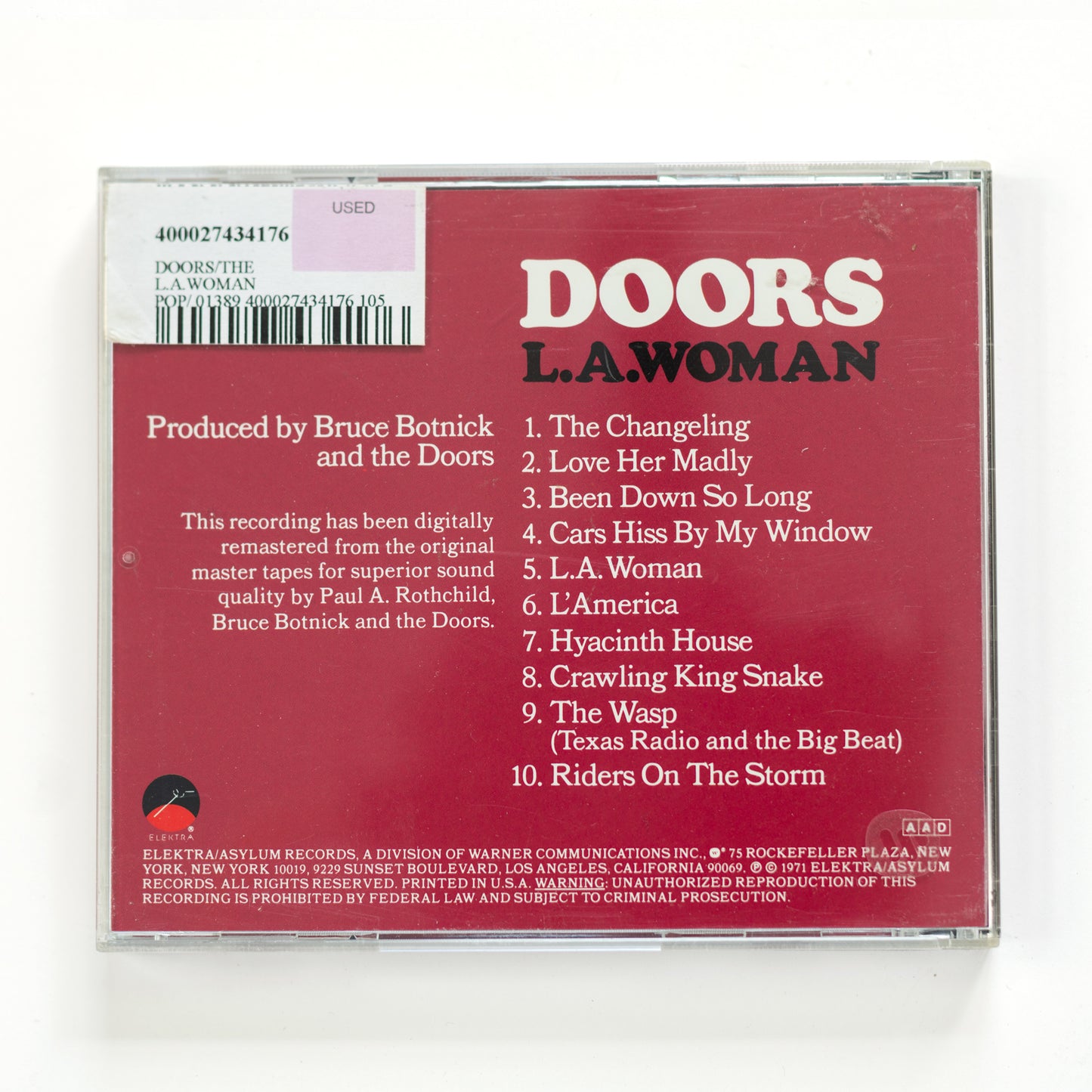 Back cover of The Doors L.A. Woman CD showing full tracklist including 'Riders on the Storm,' 'Love Her Madly,' and 'L.A. Woman,' 1971 release, a defining album in rock history blending blues, jazz, and psychedelic rock.