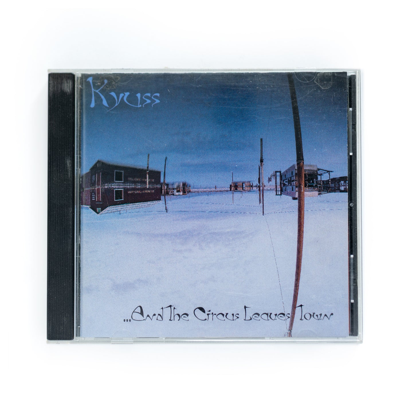 Front cover of Kyuss Circus Leaves Town CD featuring abstract, psychedelic artwork with vibrant colors and distorted imagery, 1995 stoner rock album by desert rock pioneers Kyuss, includes tracks like 'One Inch Man' and 'Thee Ol’ Boozeroony.