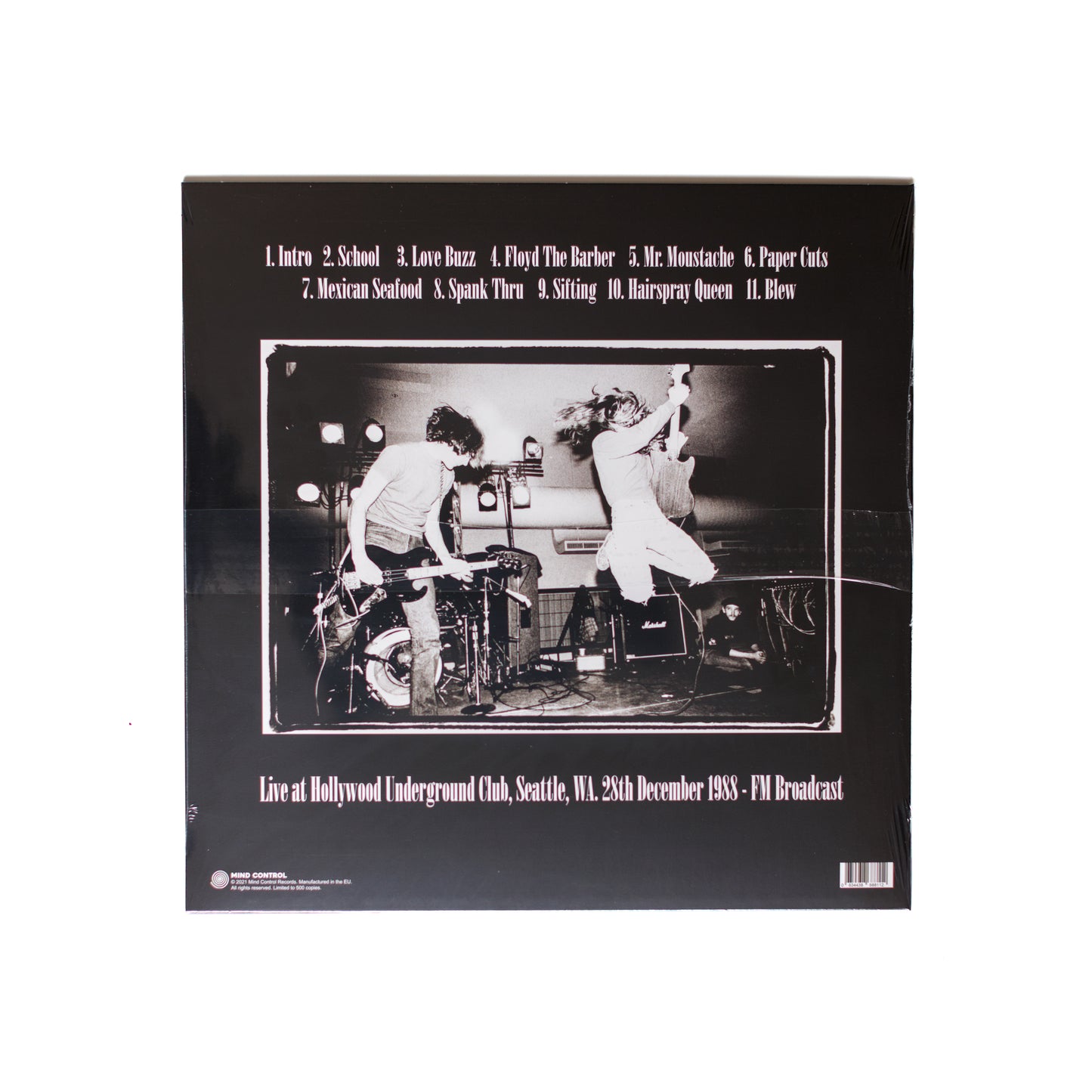 Back cover of Nirvana Hollywood Underground LP featuring 1989 live tracklist, grainy stage photo, and minimal liner notes.
