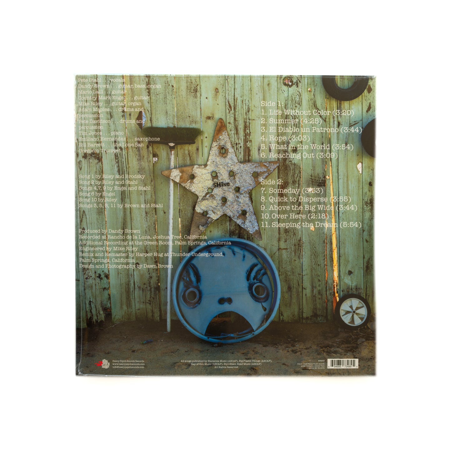 Back cover of Orquesta del Desierto – Dos vinyl LP, displaying the album tracklist in rustic font over a textured background, with band credits, label info, and atmospheric imagery that reflects the mellow, psychedelic desert rock sound of this 2003 cult favorite.