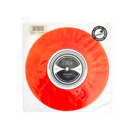 Red vinyl record in packaging with a label on a white background. Alain Johannes I Do Record Store Day.