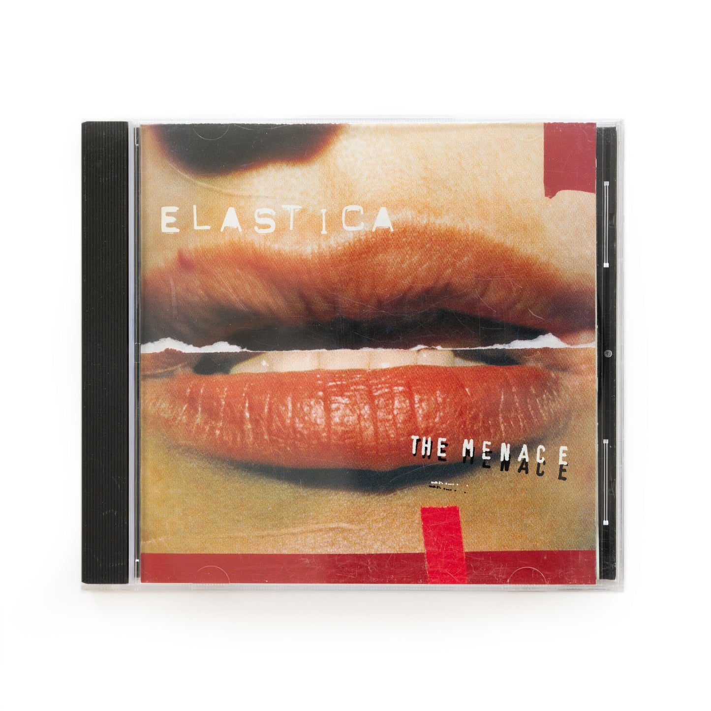 CD cover of Elastica The Menace featuring a photograph of a woman's lips.
