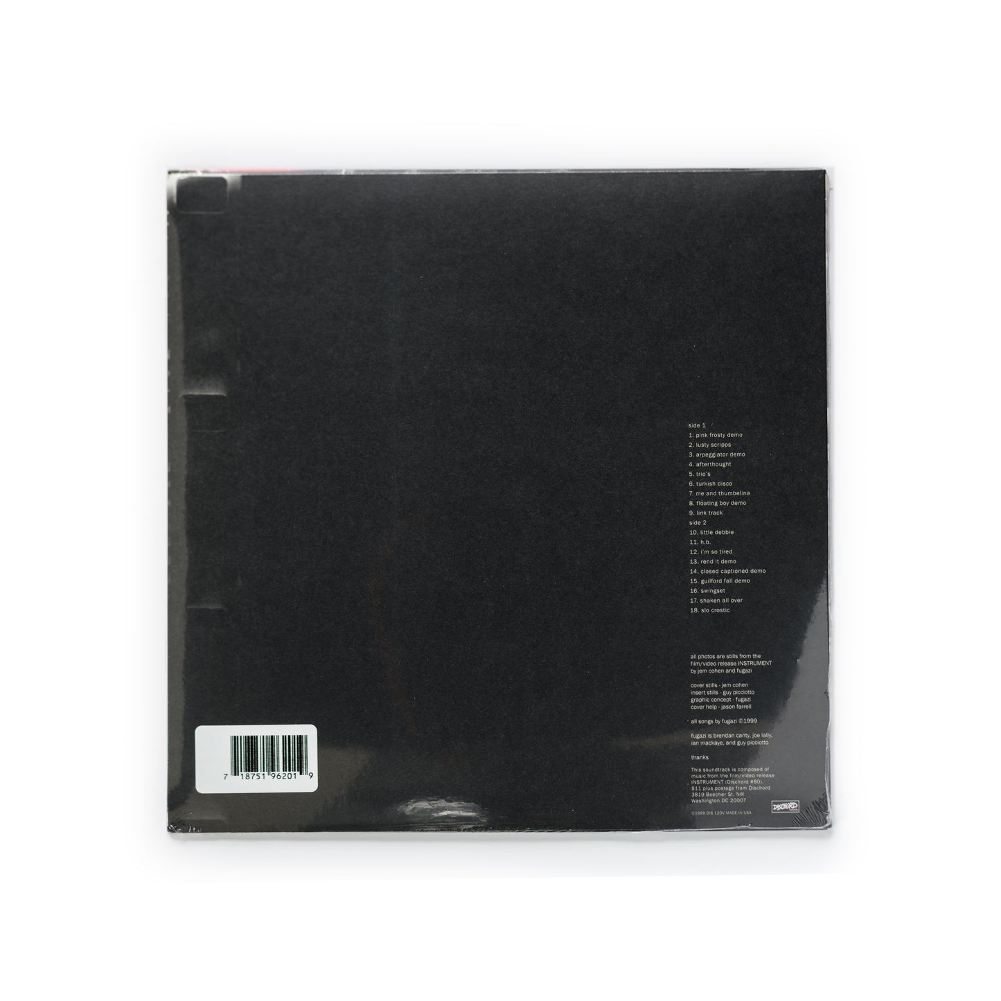 Back cover of Fugazi – Instrument Soundtrack vinyl LP, Dischord Records remastered reissue. Features full tracklist of rare demos and instrumental recordings, band credits for Ian MacKaye, Guy Picciotto, Brendan Canty, and Joe Lally, and documentary-style imagery by Guy Picciotto and Jem Cohen. A must-have release for fans of post-hardcore, DC punk, and archival vinyl soundtracks.