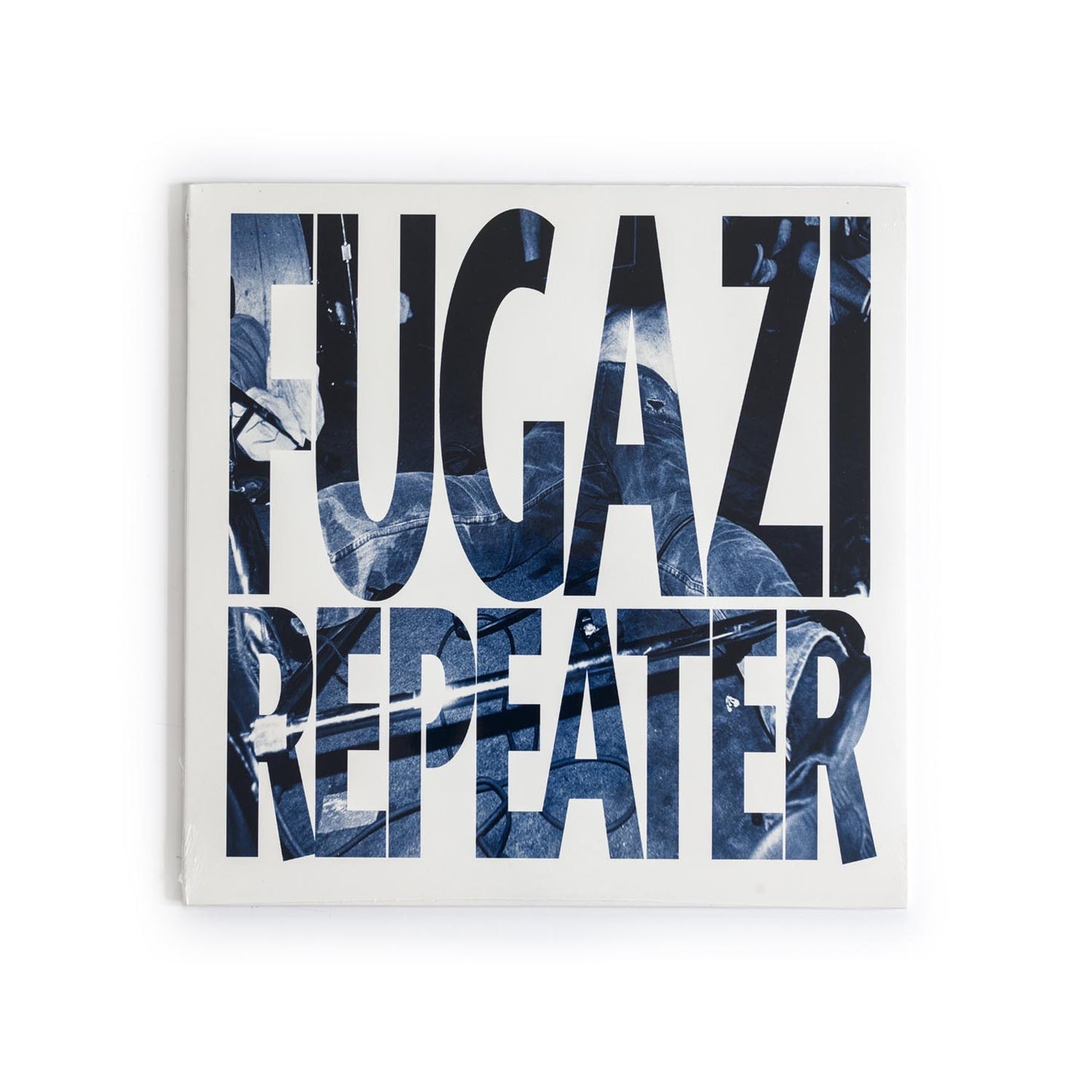 Fugazi – Repeater 2009 vinyl reissue album cover featuring blue abstract art with black background and band name in bold typeface.