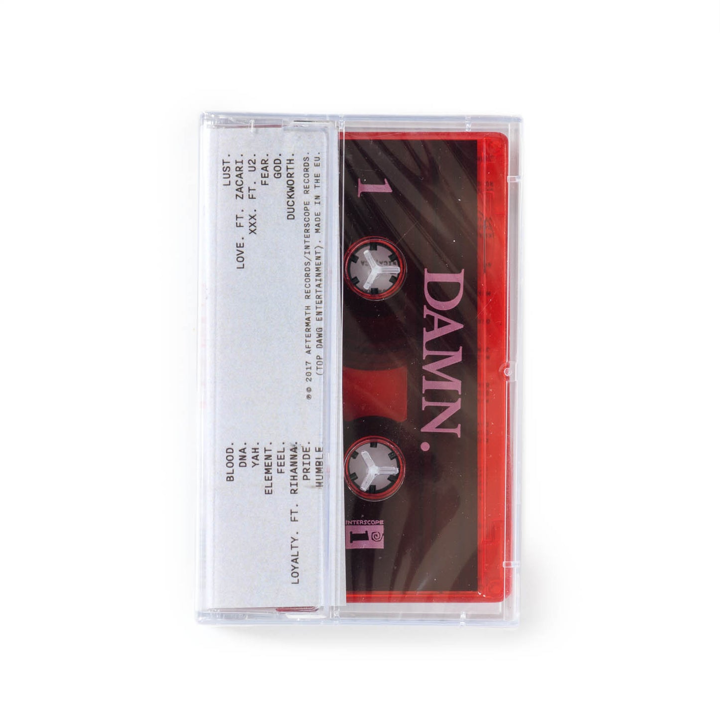 Back cover of Kendrick Lamar Damn cassette tape. A translucent red tape with DAMN. in bold white text.
