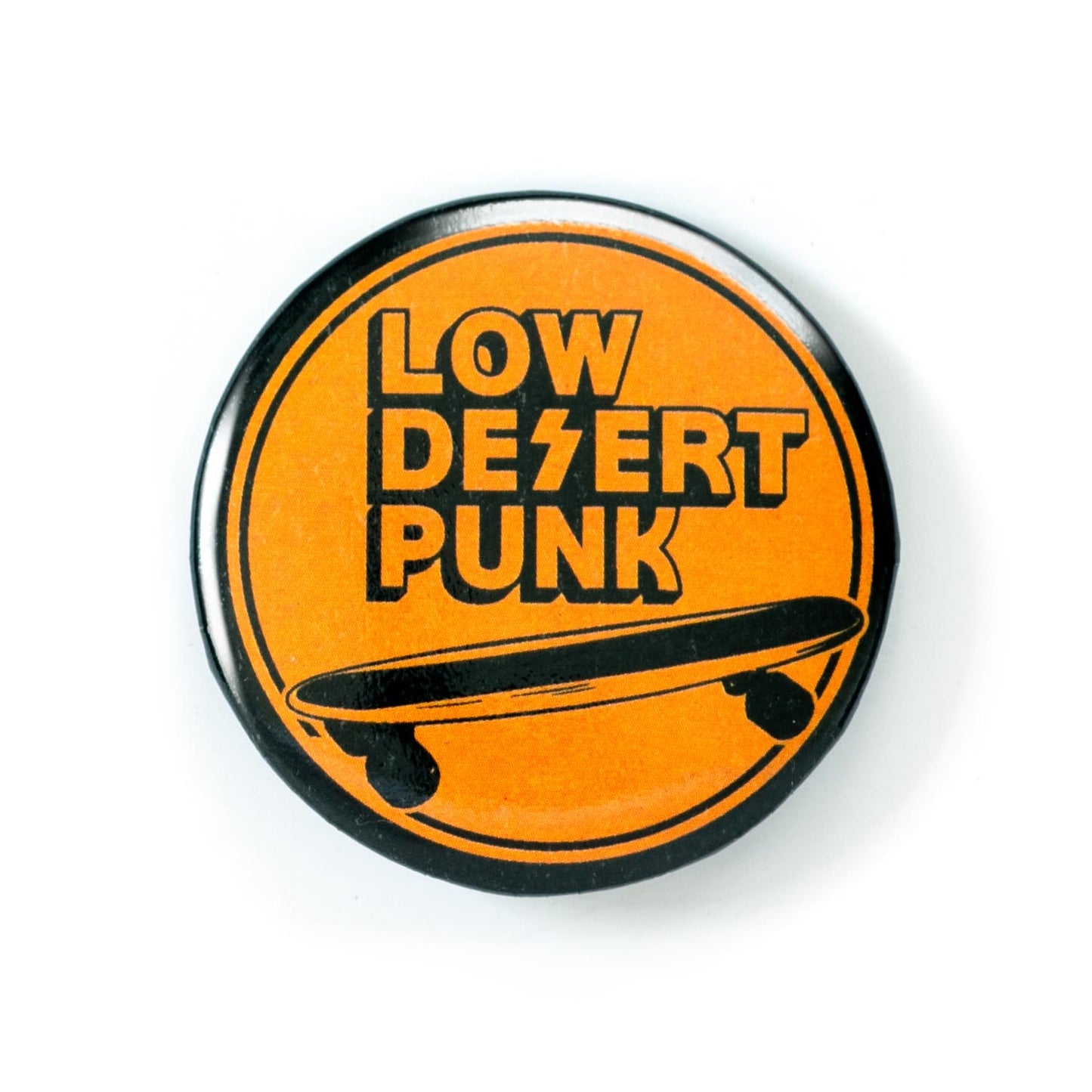 1.5 inch button with 'Low Desert Punk' text and skateboard graphic on orange background