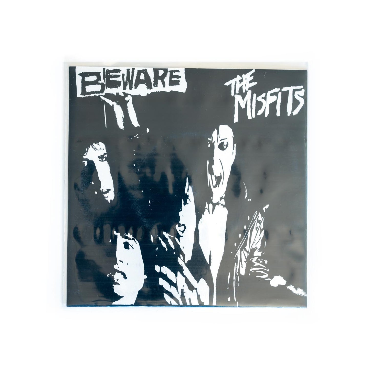Cover of Misfits Beware 7 inch. White Misfits logo and black and white, high contrast, photo of the band.