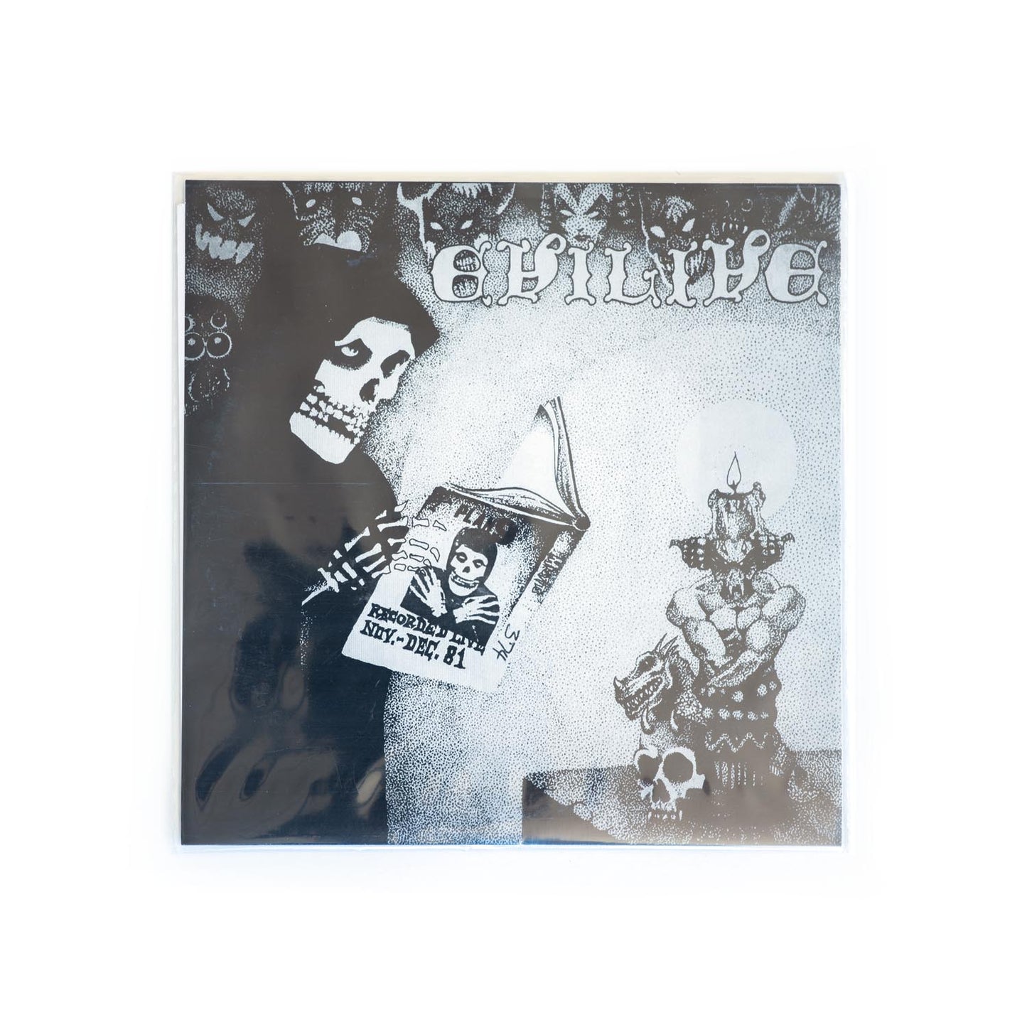 Back cover of Misfits Evillive 7 inch with black and white illustrations and text, featuring a skull and a candle.