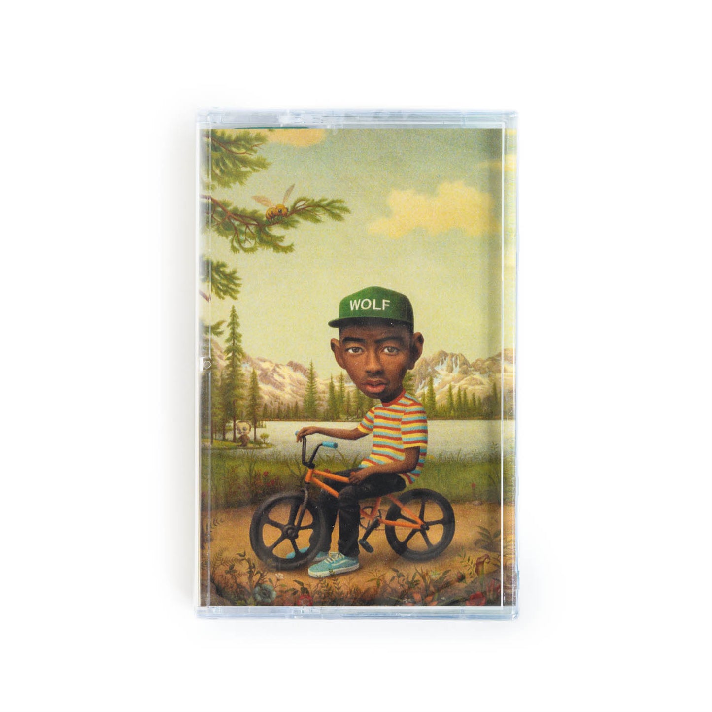 Front cover of Tyler the Creator Wolf cassette tape. This version features a painting by Mark Ryden featuring Tyler sitting on a BMX bike near a lake in the woods, wearing a hat that says Wolf.