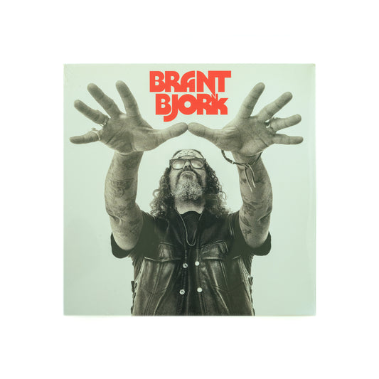 Front cover of Brant Bjork – Self-Titled vinyl LP, featuring minimalist photography of Brant Bjork with outstretched hands like a wizard. 
