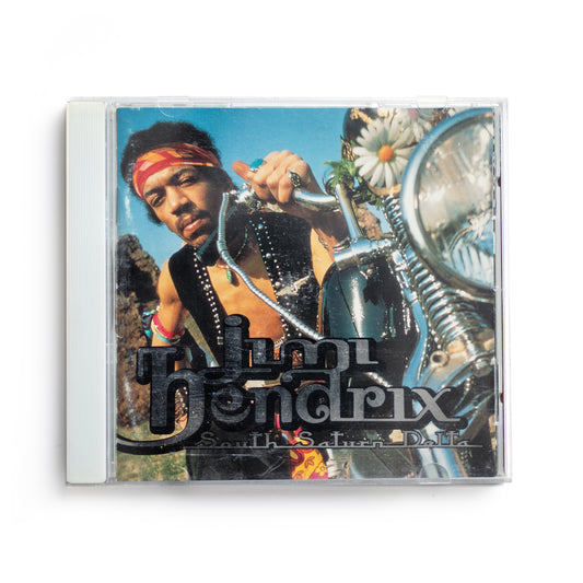 Front cover of Jimi Hendrix South Saturn Delta CD featuring bold, colorful artwork, posthumous 1997 compilation album, includes unreleased tracks and rare recordings from the legendary guitarist.