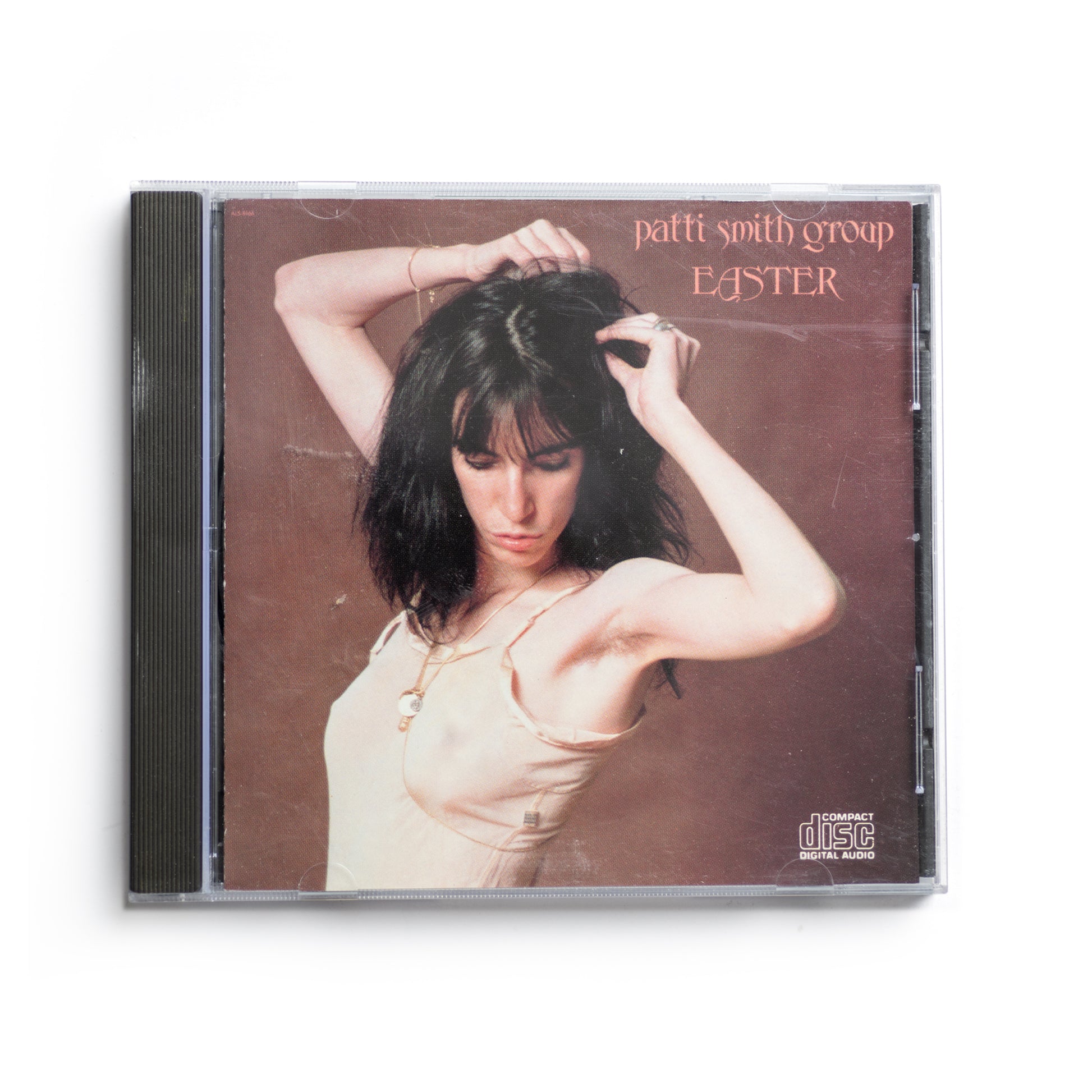 Front cover of Patti Smith Easter CD featuring a portrait of Patti Smith with bare shoulder. Iconic punk rock album, Arista Records release, includes 'Because the Night' co-written with Bruce Springsteen.