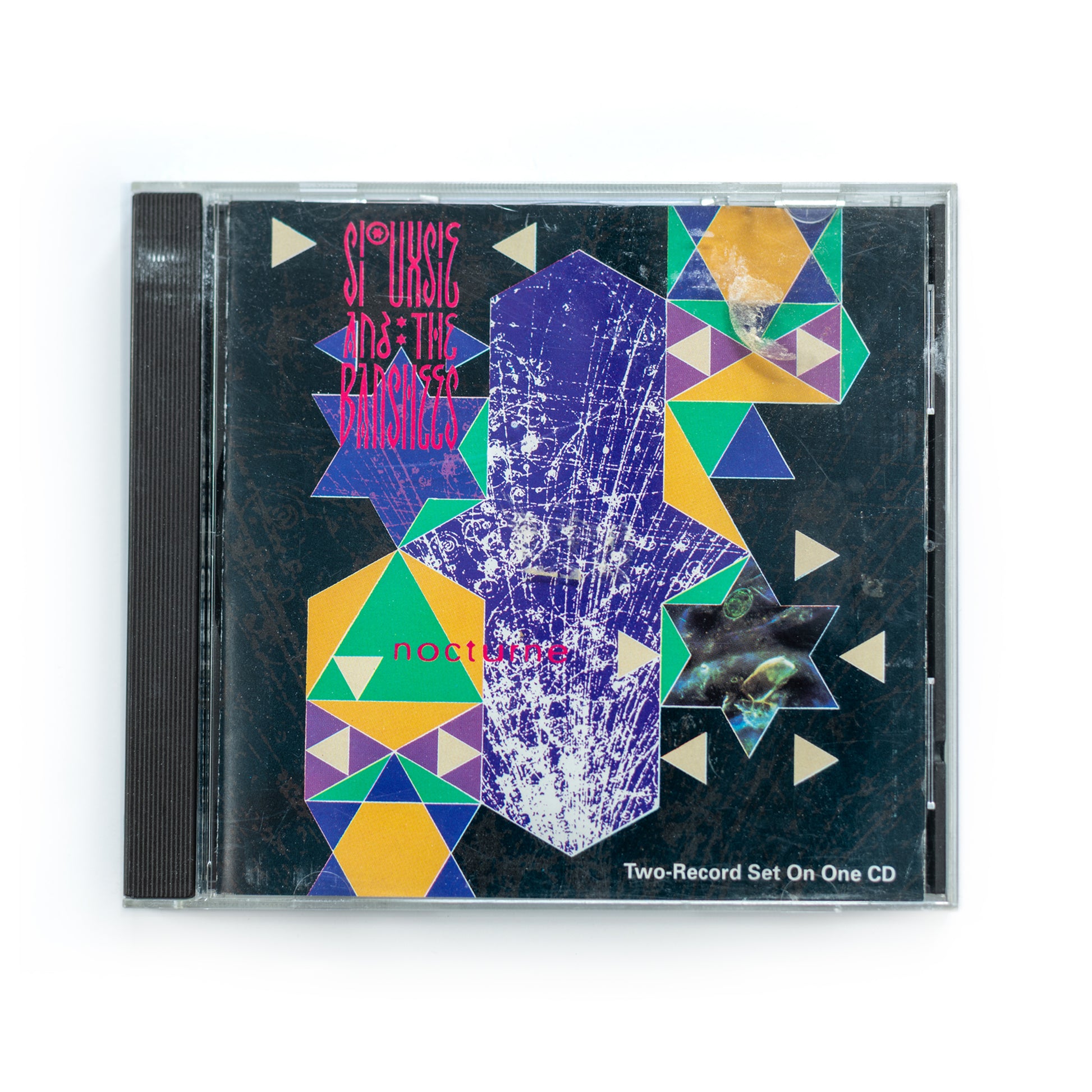Front cover of Siouxsie and the Banshees Nocturne CD featuring surreal blue-toned abstract artwork, gothic rock live album released by Polydor in 1983, post-punk music, Siouxsie Sioux iconic female fronted UK band.