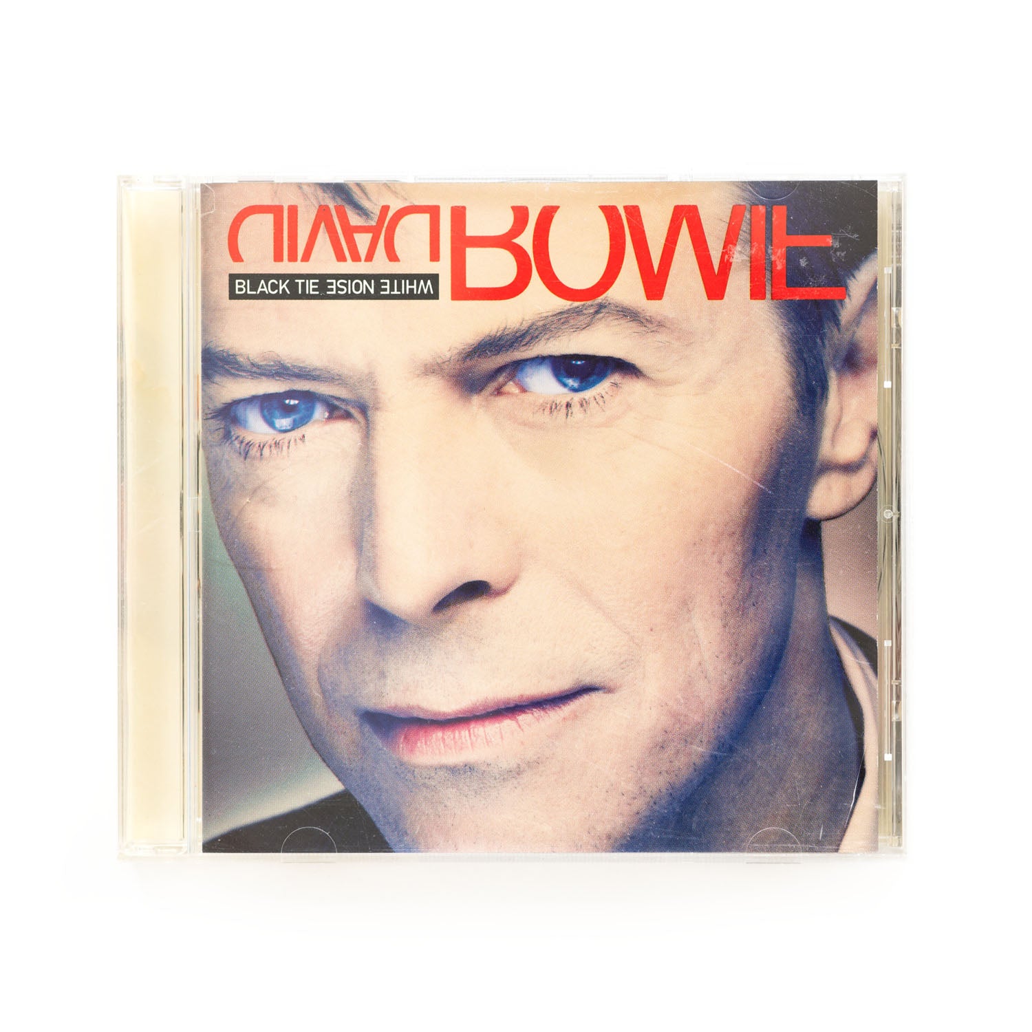 CD cover with a close up photo of David Bowie's face and the album title: Black Tie White Noise. 