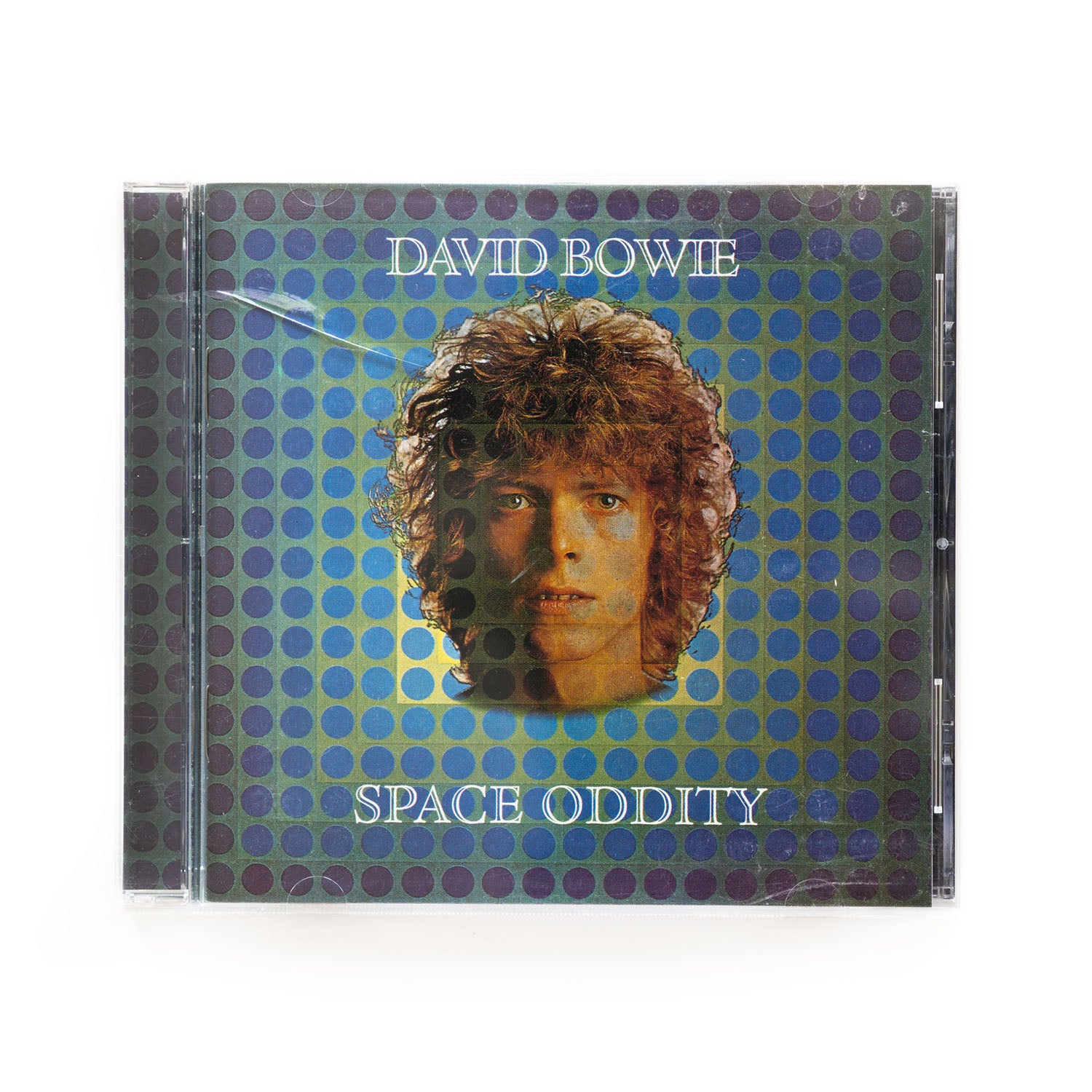 David Bowie Space Oddity cd cover. Photo of the artist's face over a background of blue and purple dots and the words David Bowie up top and Space Oddity below. 