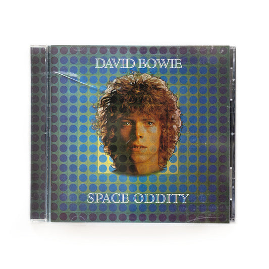 David Bowie Space Oddity cd cover. Photo of the artist's face over a background of blue and purple dots and the words David Bowie up top and Space Oddity below. 