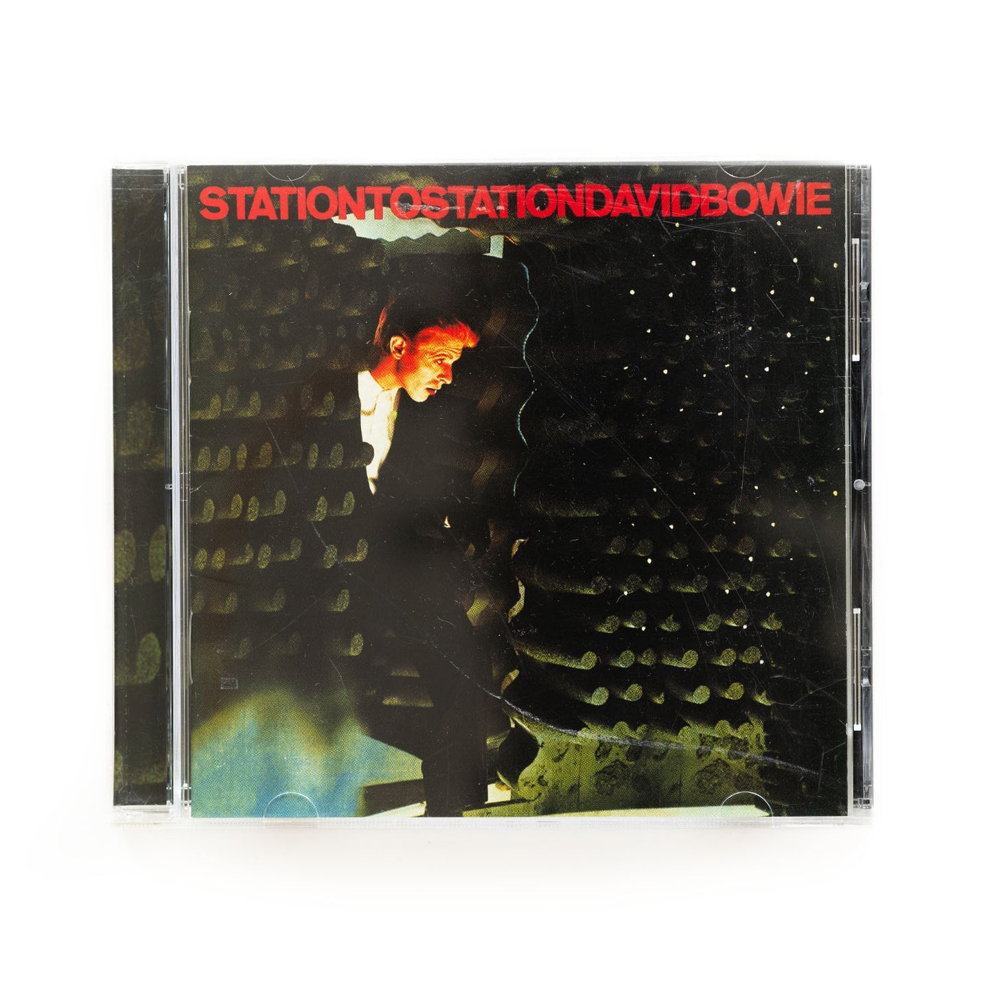 CD cover of David Bowie Station to Station with a photograph of Bowie stepping out of an industrial looking scene. 