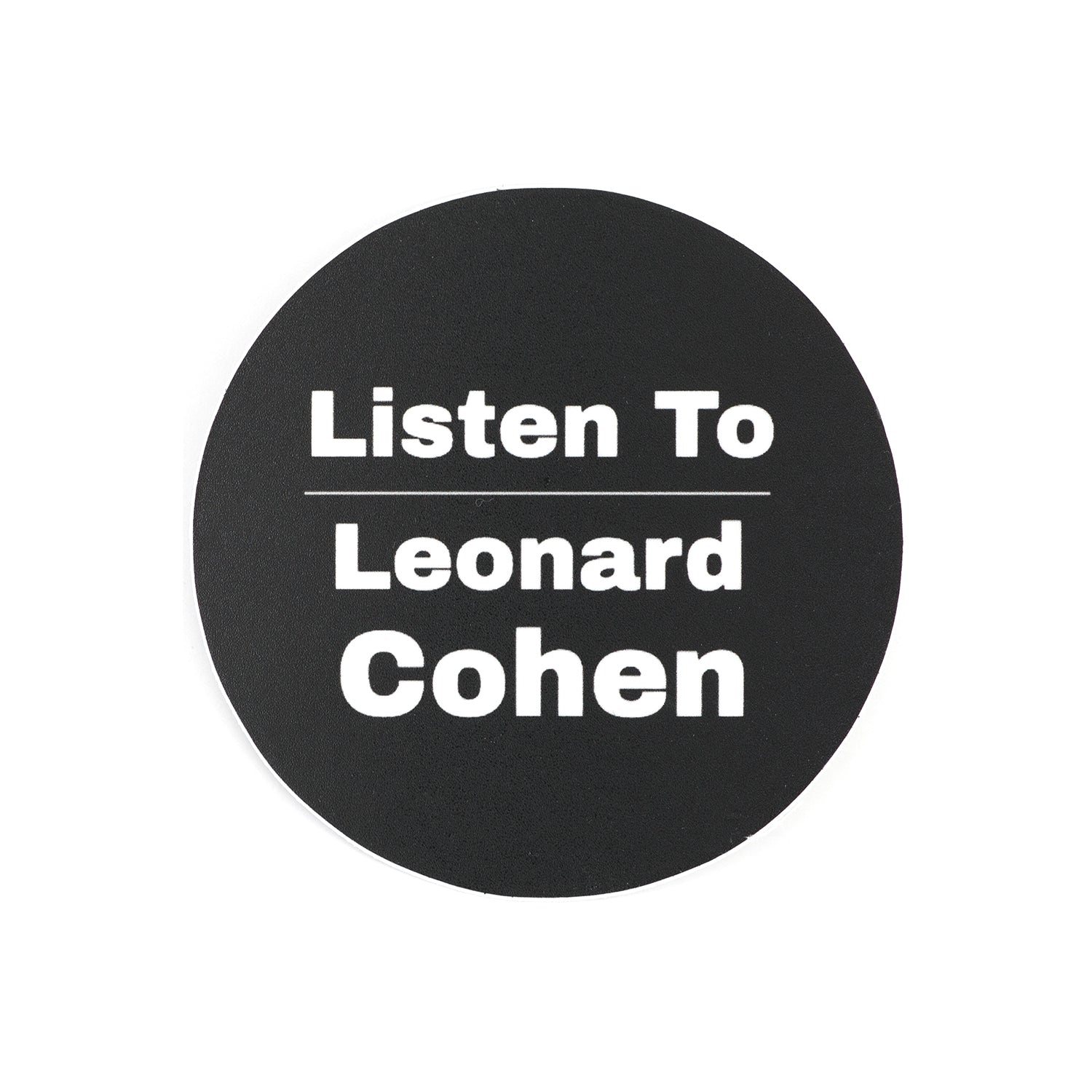 Photo of three inch round, black sticker with white writing that reads, Listen To Leonard Cohen.