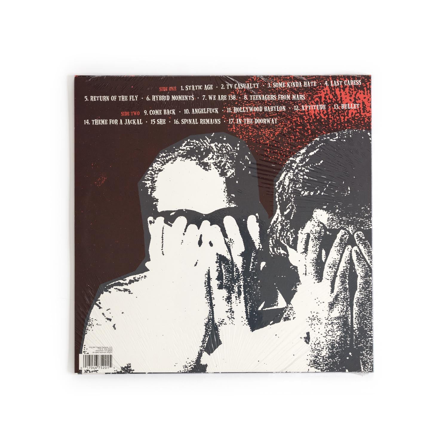 Back cover of Static Age vinyl showing complete tracklist, credits, Capitol Records barcode, and a black/red layout with minimalist punk design elements.
