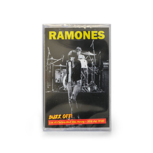 Cover of Ramones Buzz Off! cassette tape featuring a black and white live shot with Joey Ramone in front and Marky Ramone behind him. 