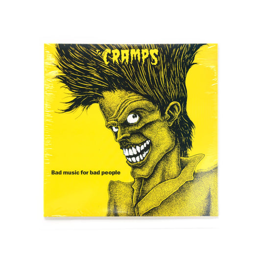 The Cramps – Bad Music For Bad People LP cover featuring yellow background and iconic black ghoul illustration with wild hair and sinister grin.