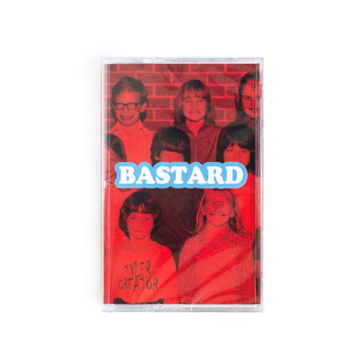 Cassette tape cover of Tyler the Creator Bastard album. The word Bastard in white text surrounded by a blue outline sits in the center over a red tinted school photo. One of the kids has a Tyler the Creator shirt on. 